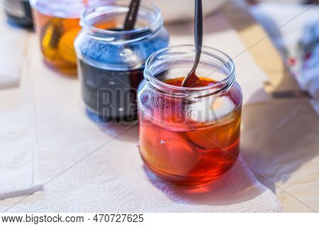Easter Eggs Color At Home In The Kitchen With Cucumber Glasses And Various Colors, Germany