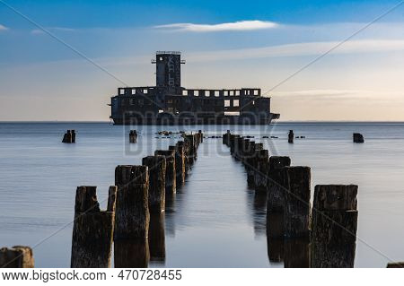 Gdynia, Poland - April 2022: Old Ruins Of Torpedo Room And Old Wooden Pier On The Baltic Sea Next To