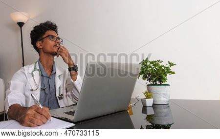Brazilian Black Doctor Or Veterinarian Working At Home. Young Man Doing Home Office During The Day A