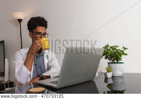 Brazilian Black Doctor Or Veterinarian Working At Home. Young Man Doing Home Office During The Day A