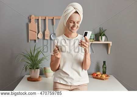 Attractive Woman Relaxing At Home And Reading Messages On Mobile Phone, Happy Caucasian Girl Wrapped