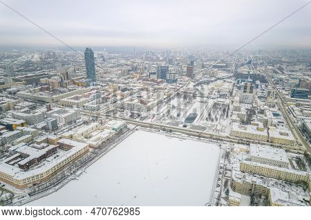 Embankment Of Central Pond And Plotinka In Yekaterinburg At Winter Sunset. Winter Snow-covered City.