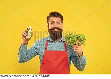 Happy Man In Apron Holding Fresh Lettuce And Juice Bottle Yellow Background, Juicery