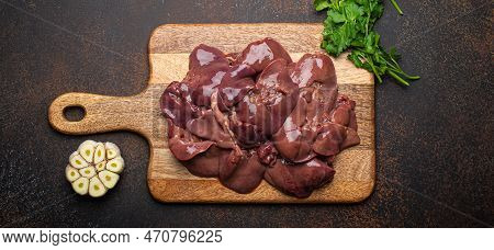 Raw Chicken Liver On Wooden Cutting Board Top View On Dark Rustic Concrete Background Kitchen Table 