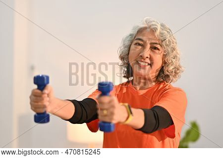 Active Middle Aged Woman Womanexercising With Dumbbells At Home. Retirement, Healthy Lifestyle Conce
