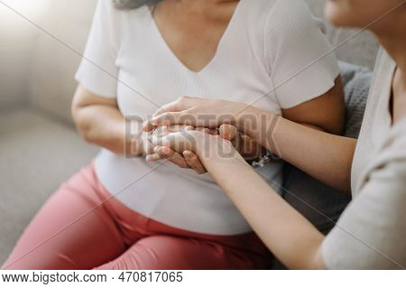 Hands Of The Old Woman And A Wman Hand In Home