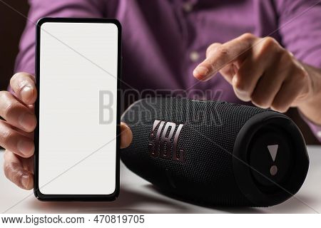 Dnioro Ukraine. 27 January 2023: Man Holding Smartphone With White Screen And Use Portable Music Spe
