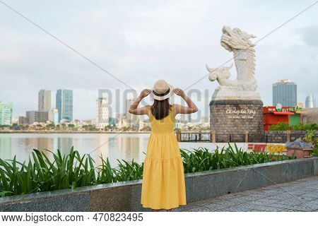 Woman Traveler  Visiting In Da Nang. Tourist Sightseeing The River View With Carp Dragon Statue Or C
