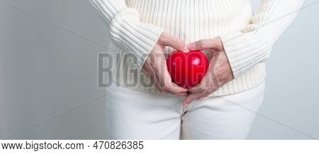 Woman Holding  Red Heart Shape. Pregnancy, Reproductive System, Menstruation, And Gynecology Concept