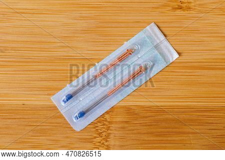 A Closeup Portrait Of Tin Acupuncture Needles With A Copper Handle Still In The Package, Ready To Us