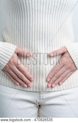 Woman Holding  Her Belly. Pregnancy, Reproductive System, Menstruation, And Gynecology Concept