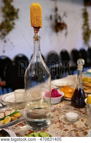 Big Bottle Of Vodka With Cob Of Corn As A Stopper Of A Bottle, Close-up.