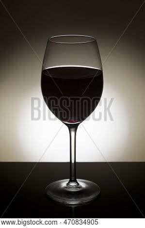 Close-up On A Red Wine In A Backlit Glass.