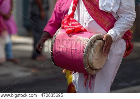 Close-up On A Musician Playing With A Dholak During A Tamil Festival.
