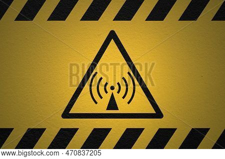 Black Striped Yellow Background With A Danger Non-ionizing Radiation Sign And A Light Effect To Dram