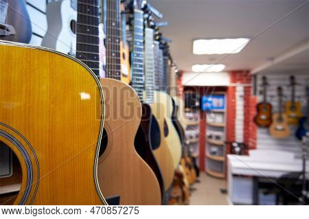 Different Acoustic Six-string Guitars In A Music Store