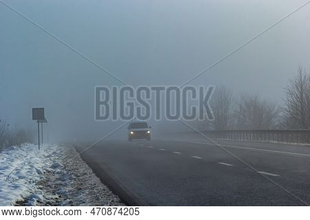 Driver Of Almost Empty Grey Foggy Misty Rainy Highway Intercity Road With Low Poor Visibility On Col