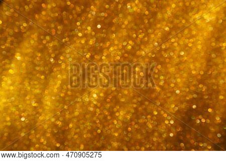 Bokeh Light Of Gold Glitters. Golden Glitter Texture Background. Sparkling Glitter Wrapping Paper Wi