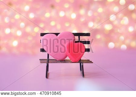 Two Red Hearts On Bench Pink Background With Bokeh