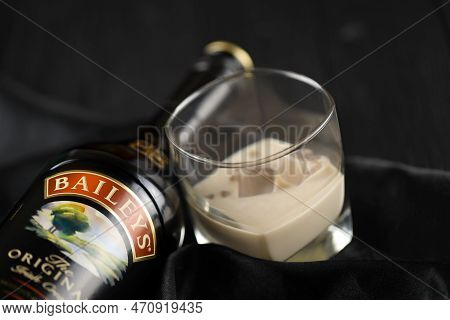 Kyiv, Ukraine - May 4, 2022 Baileys Original Alcohol Bottle On Wooden Table With Black Fabric On Bac