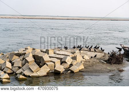Concrete Block. Gray Cement Cinder Block Isolated On River Side. Granite Bolder In Infront Of River.