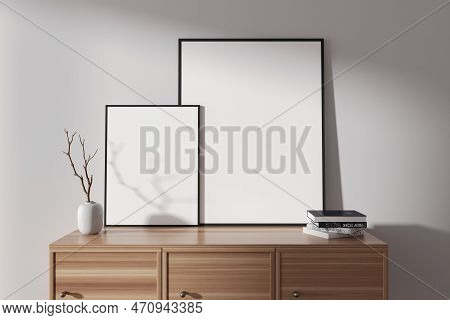 Front View On Bright Living Room Interior With Two Empty White Posters, Sideboard, White Wall, Books