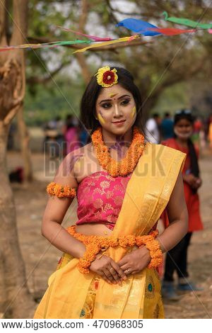 Portrait Of Beautiful Happy Young Indian Woman With Spring Festive Make Up Celebrating Holi With Pow