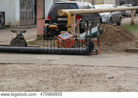 Tiraspol, Moldova - 13, February, 2023: Plastic Pipe Welding Machine And Industrial Sewer Pipes. Lay