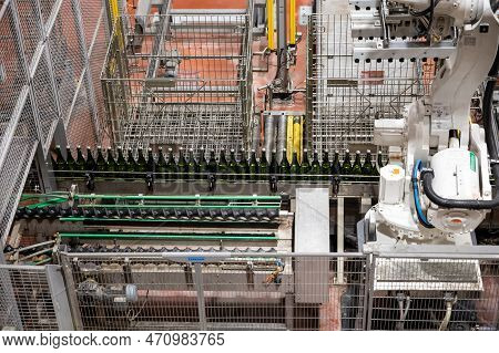 Production Of Cremant Sparkling Wine In Burgundy, France. Automatically Powered Bottling Lines On Fa