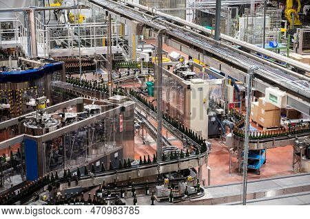 Production Of Cremant Sparkling Wine In Burgundy, France. Automatically Powered Bottling Lines On Fa