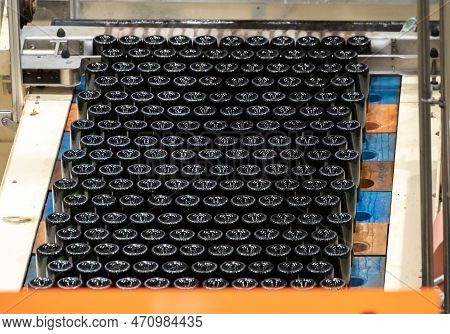 Production Of Cremant Sparkling Wine In Burgundy, France. Automatically Powered Bottling And Riddlin