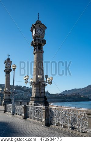 Walking On Promenade Along White Sandy La Concha Beach In Central Part Of Donostia Or San Sebastian