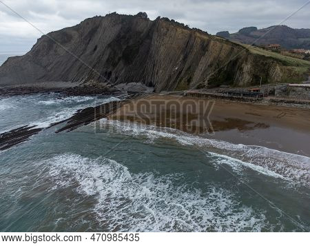 View On Sandy Beach, Rocks And Atlantic Ocean In Zumaia Touristic Ciry, Basque Country, Spain