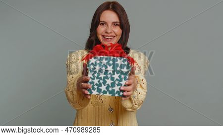 Positive Smiling Pretty Woman Presenting Birthday Gift Box Stretches Out Hands, Offer Wrapped Presen