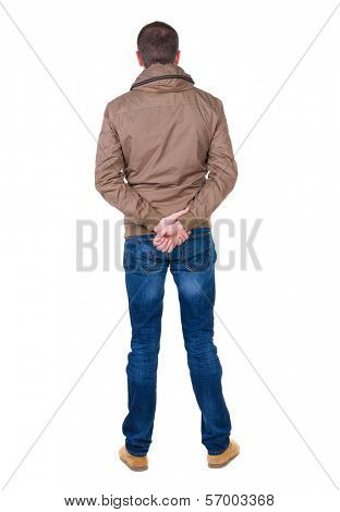 Back view of handsome man in brown windcheater looking up.   Standing young guy in jeans. Rear view people collection.  backside view of person.  Isolated over white background.