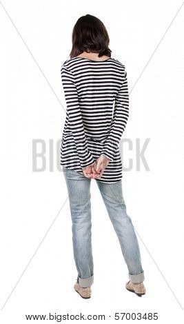 back view of standing young beautiful  brunette woman in striped frock. girl  watching. Rear view people collection.  backside view of person.  Isolated over white background.