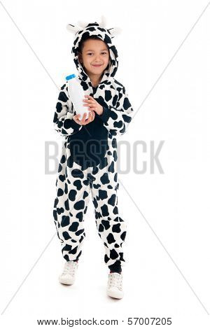 Little boy dressed as cow with bottle of milk
