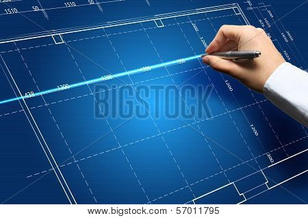 Hand and blueprint - engineer working on blue print concept