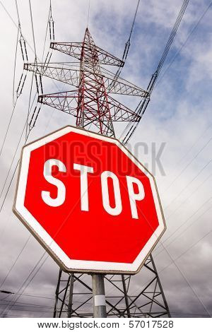 a poles of a power line and a stop sign. symbolic photo for phasing out nuclear power