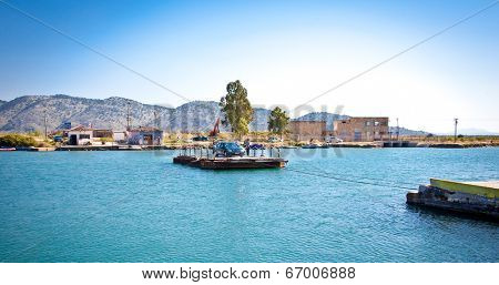 BUTRINT, ALBANIA-JUNE 6, 2014:  Traditional old ferry boat with passengers and cars crosses the Vivari Channel in Butrint on June 6, 2014, Albania.
