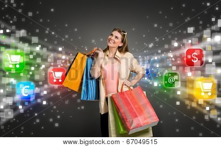 happy shopping woman surrounded by glow icons of e-commerce