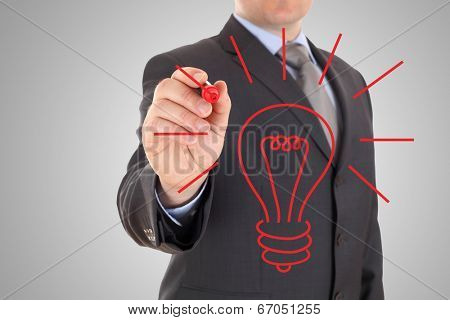 Businessman drawing lightbulb