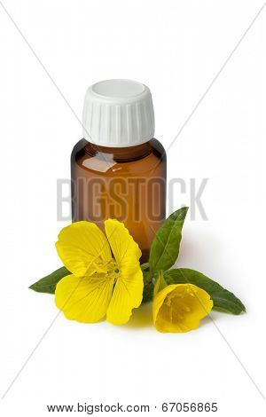 Bottle with  Evening Primrose oil and fresh flower on white background