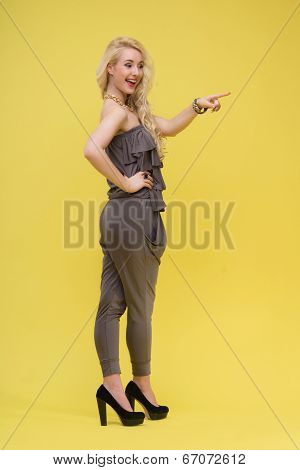Woman standing on yellow background