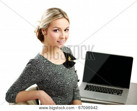 young woman with a laptop sitting isolated on white background