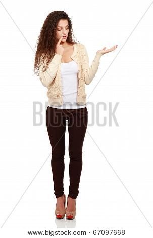 portrait of pretty happy young woman pointing at copyspace, isolated on white background