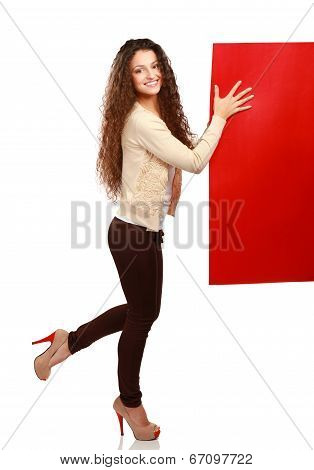 Portrait of a young woman holding blank card - over white background