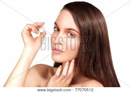 Beautiful Model Applying A Cosmetic Skin Serum Treatment