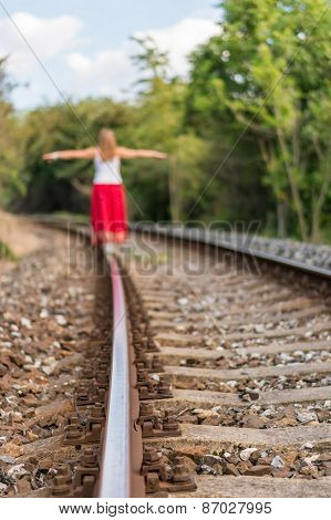 Girl Walking On Rails
