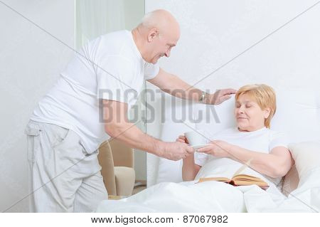 Man brings tea to his wife